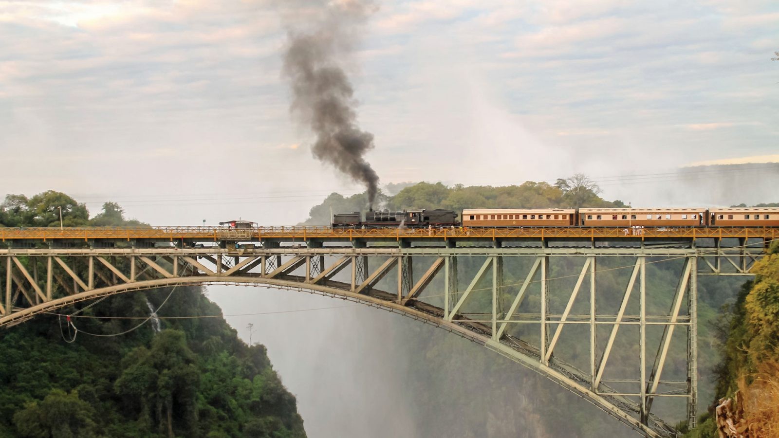 train-crossing-famous-victoria-falls-bridge-in-zimbabwe-1600x900